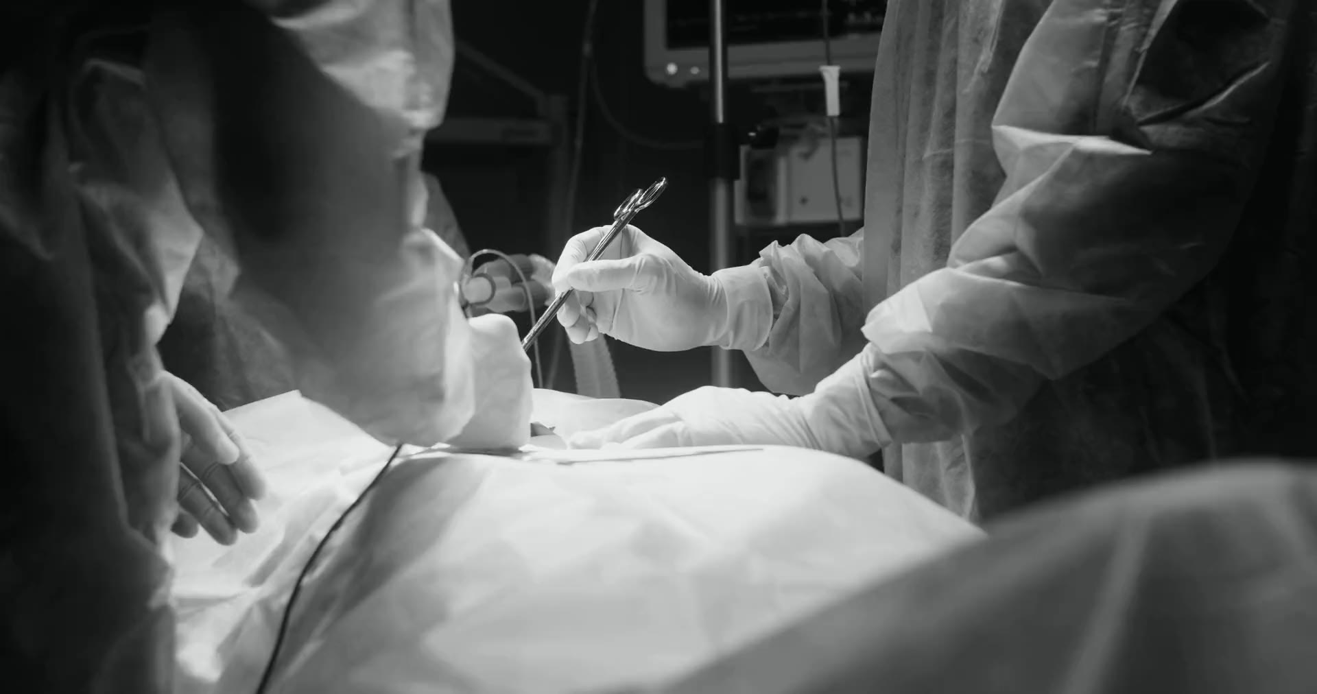 Surgeons operating in a softly lit operating room