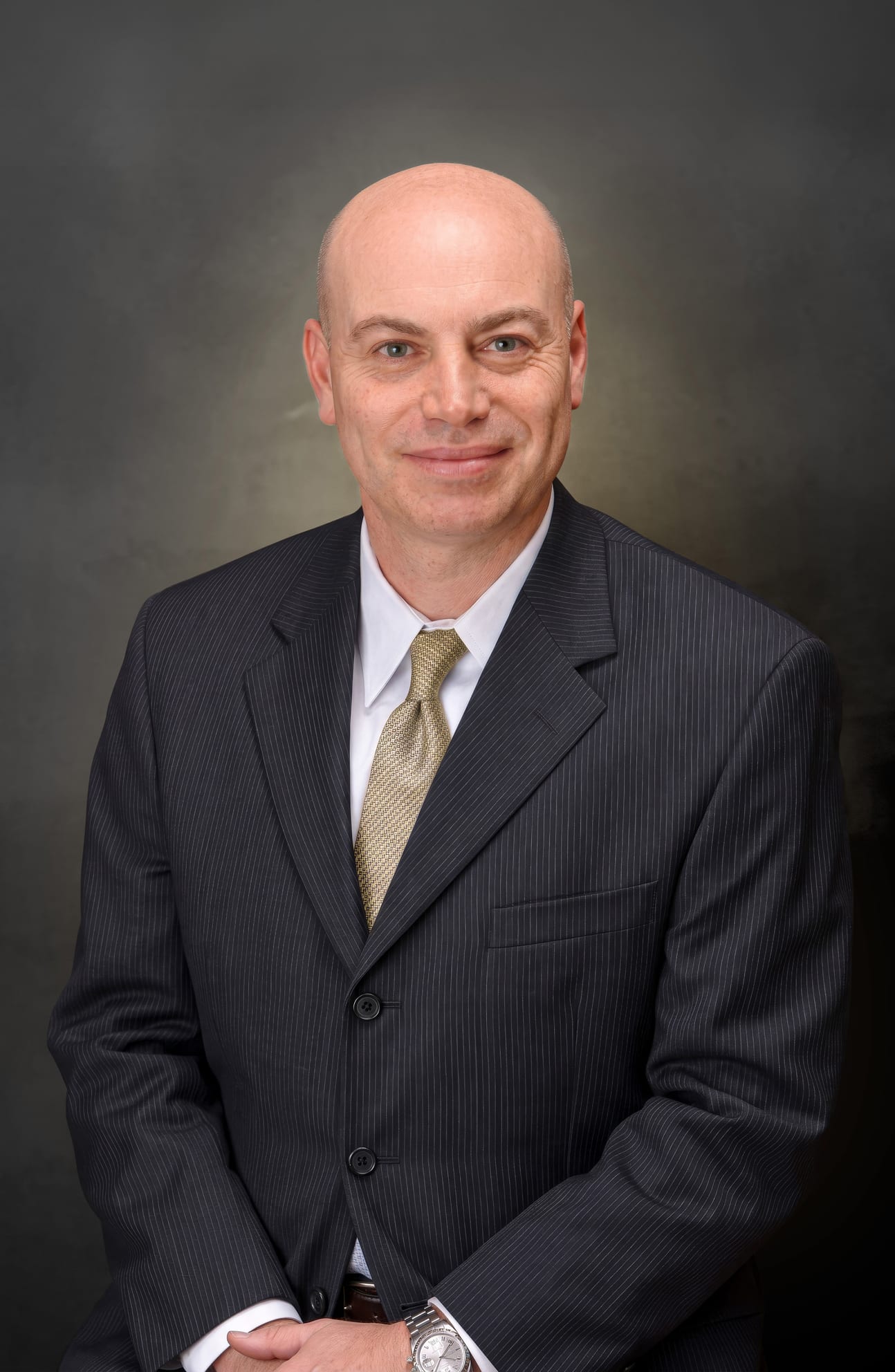 Dr. Arthur Shektman, board-certified plastic surgeon at Finesse Cosmetic Surgery, in a dark suit