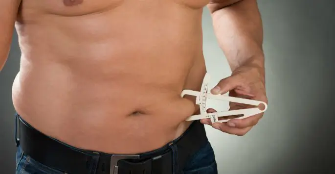 a man measuring his waist