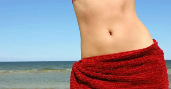 a person's stomach wrapped in a red towel