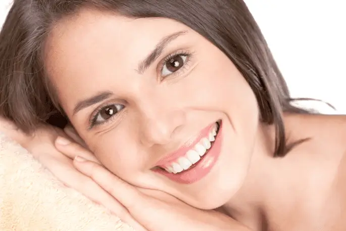 Close-up view of a person's shoulder with brown hair draped over it.